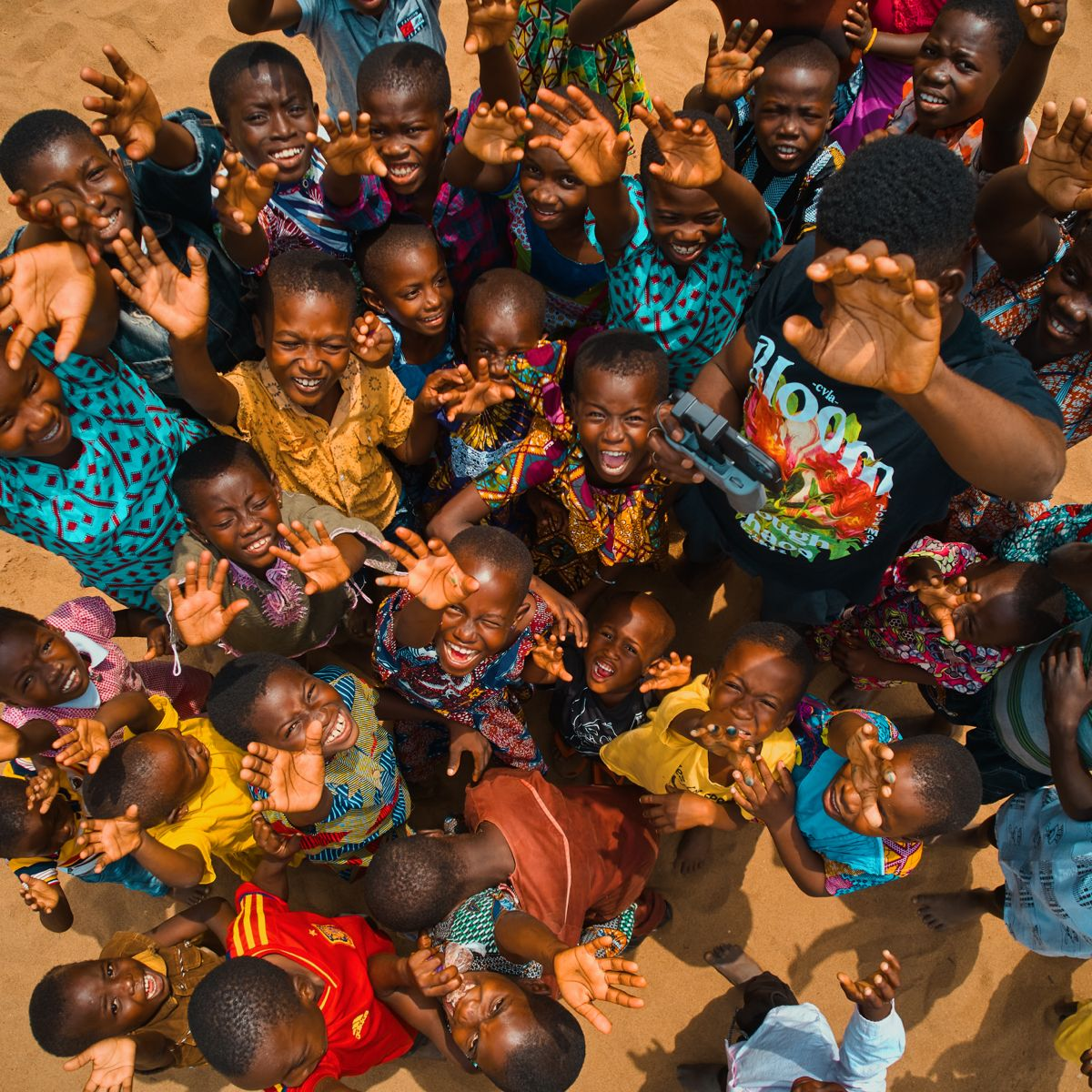 Joyful African children reaching up — the heart of our community